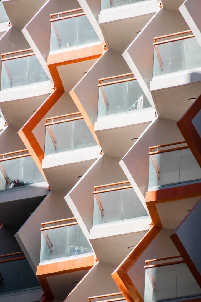 Zigzag geometric orange and white balconies on a modern Dubai apartment building facade