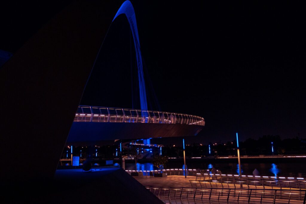 Illuminated arch bridge over the Dubai Water Canal at night, representative of the canal-front Business Bay setting of Capital Bay Towers