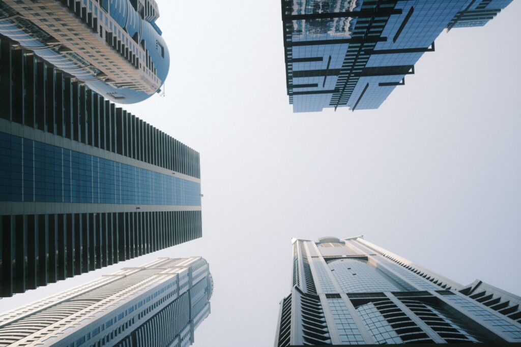 Low-angle view of modern glass high-rise apartment towers against a clear sky in Downtown Dubai