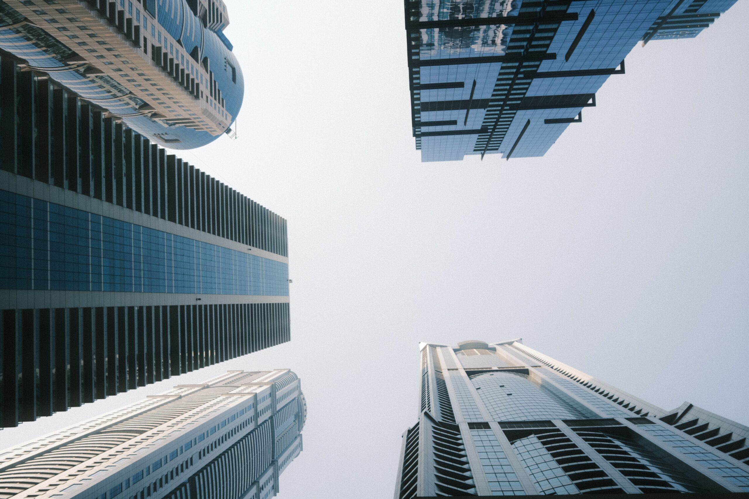 Low-angle view of modern glass high-rise apartment towers against a clear sky in Downtown Dubai