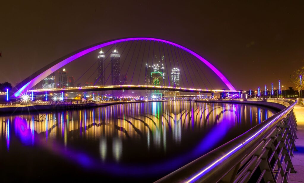 Illuminated Tolerance Bridge arching over the Dubai Water Canal at night in Business Bay, Dubai