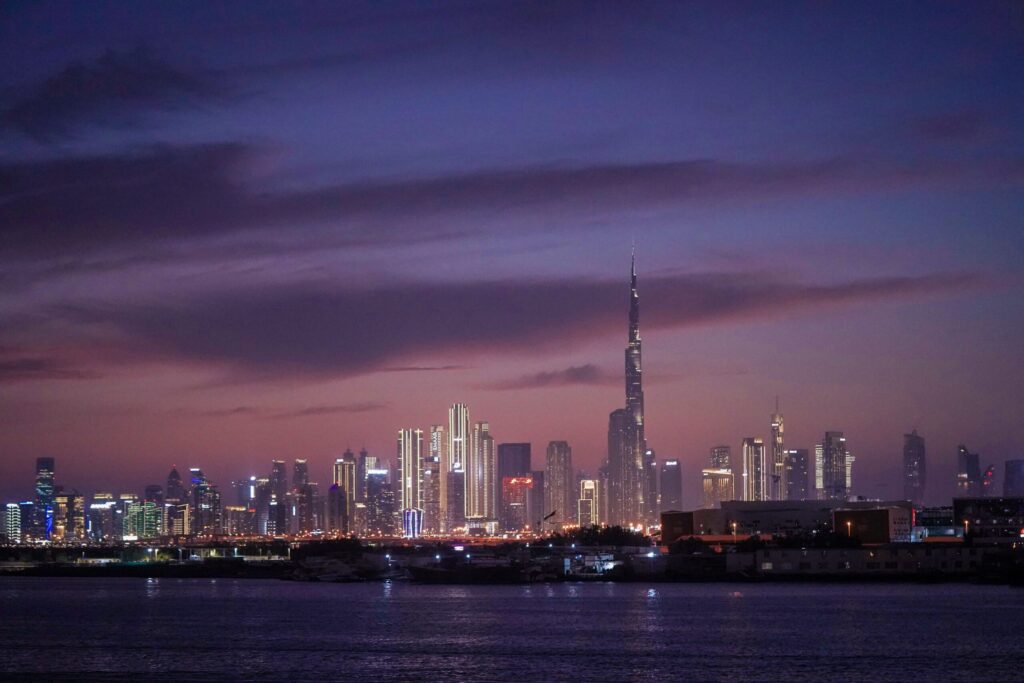 Dusk skyline view of Business Bay and Downtown Dubai with Burj Khalifa illuminated, near Bayz 102