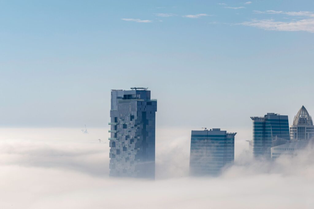 Dubai skyscrapers rising above a layer of fog