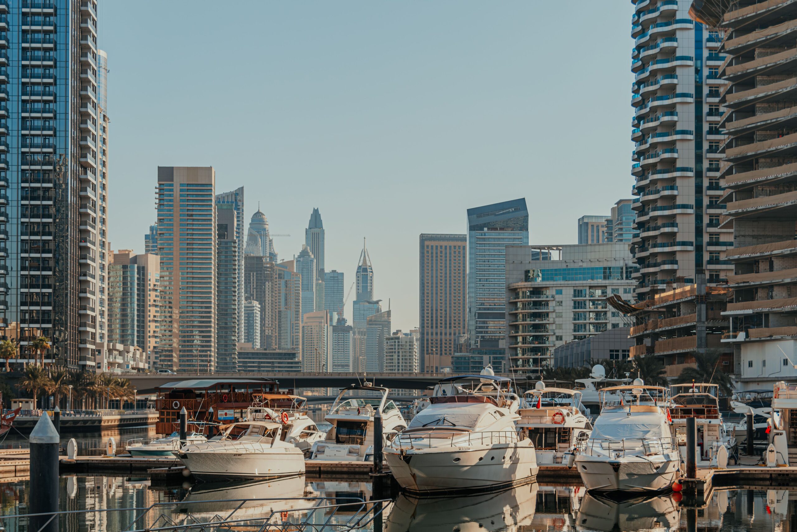 Dubai Marina waterfront skyline with high-rise towers and moored yachts along the promenade