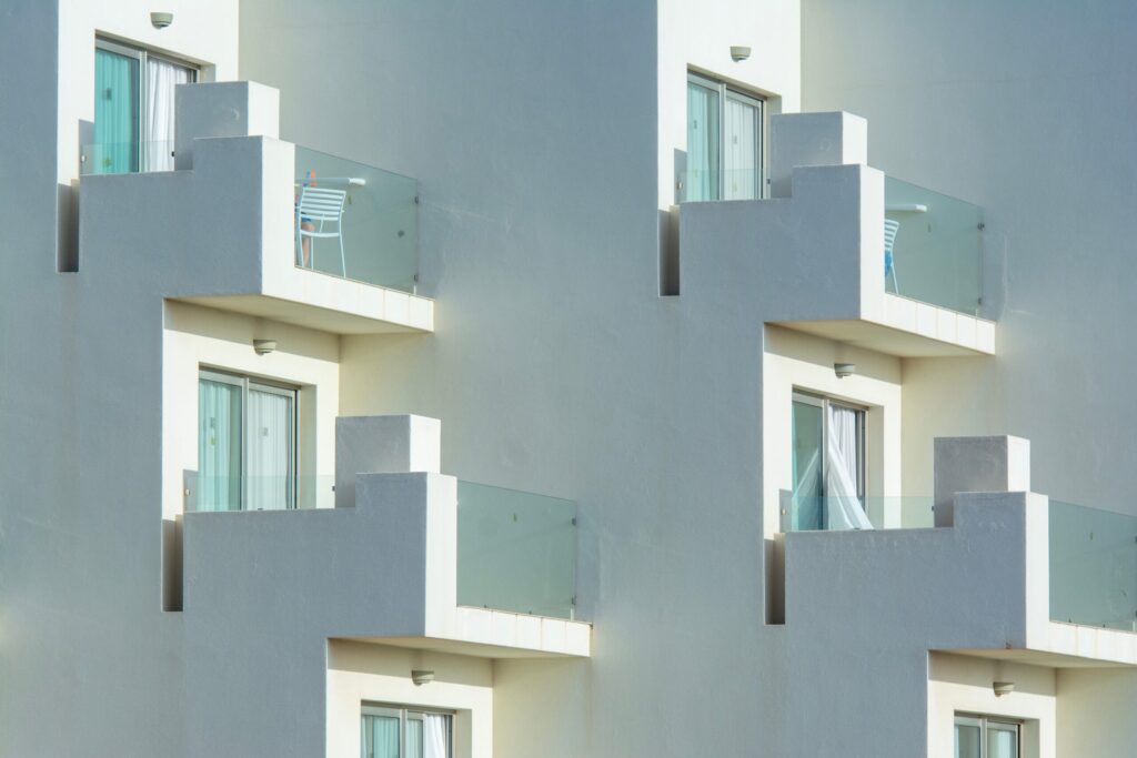 Close-up of a modern grey and white apartment balcony facade, similar to Wilton Park Residences, Sobha Hartland
