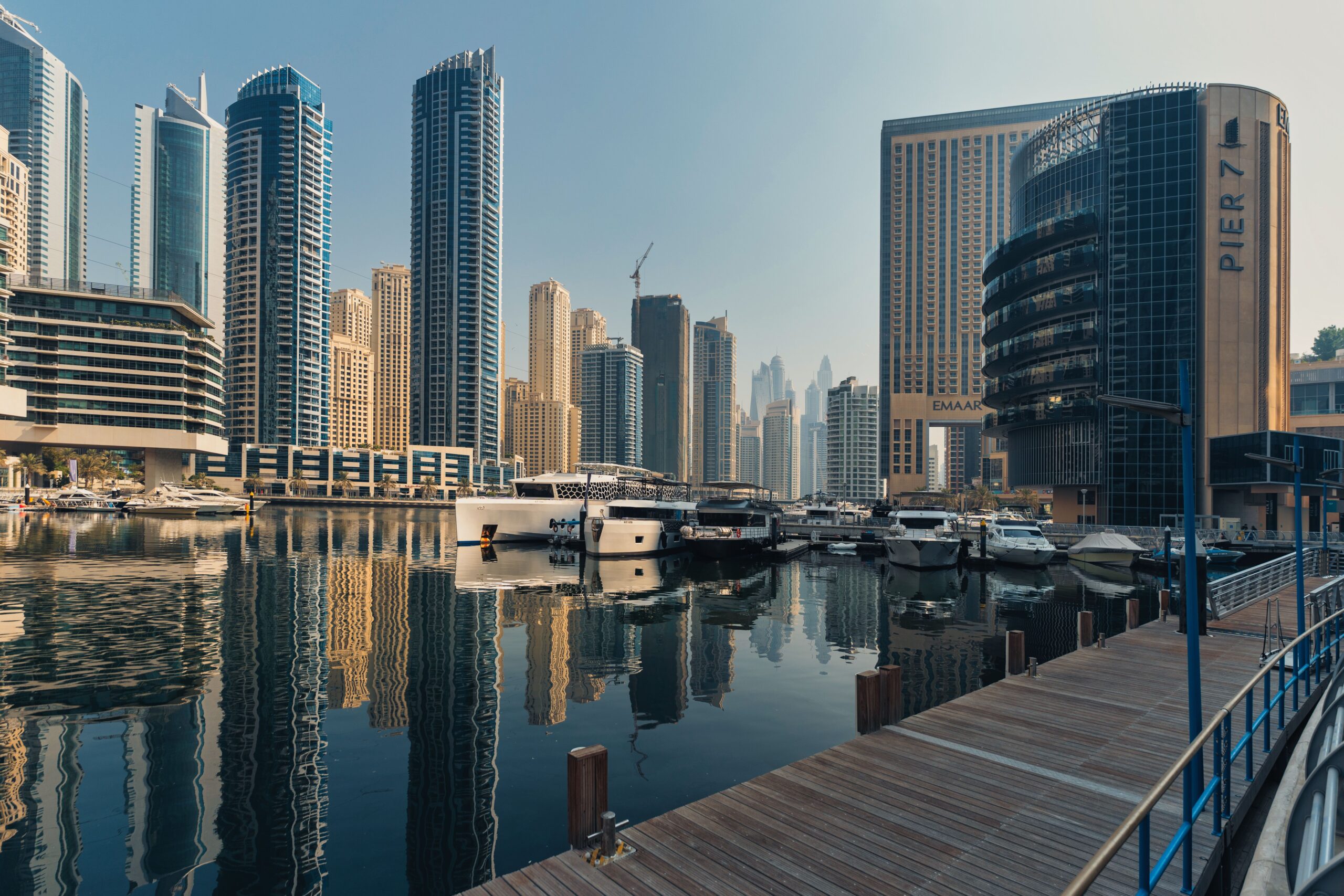 Dubai Marina towers reflected in the marina water on a clear morning