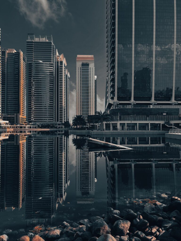 Jumeirah Lake Towers skyscrapers reflecting in calm water at dusk, representative of Lake Point Tower in JLT Cluster N