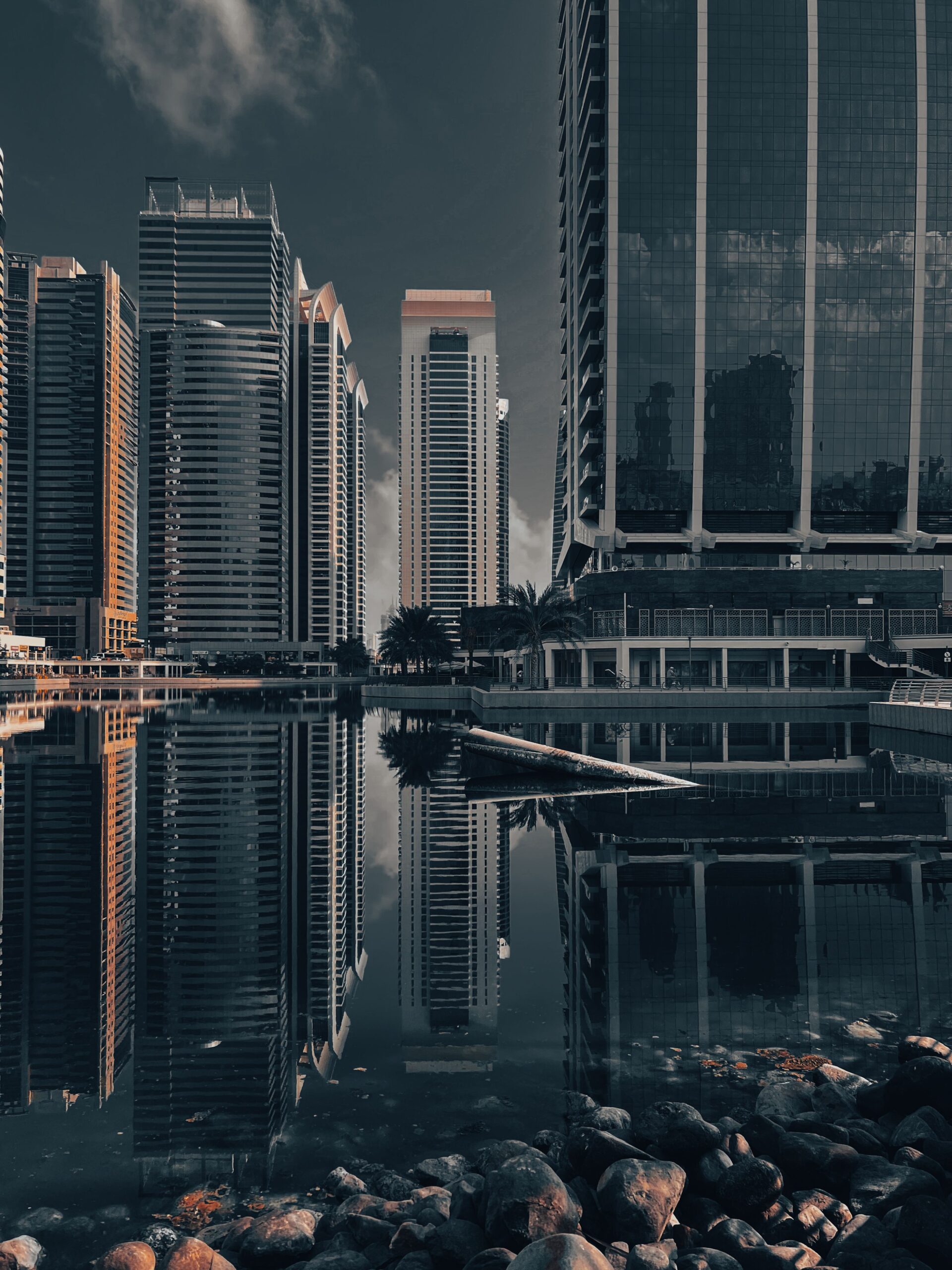 Jumeirah Lake Towers skyscrapers reflecting in calm water at dusk, representative of Lake Point Tower in JLT Cluster N