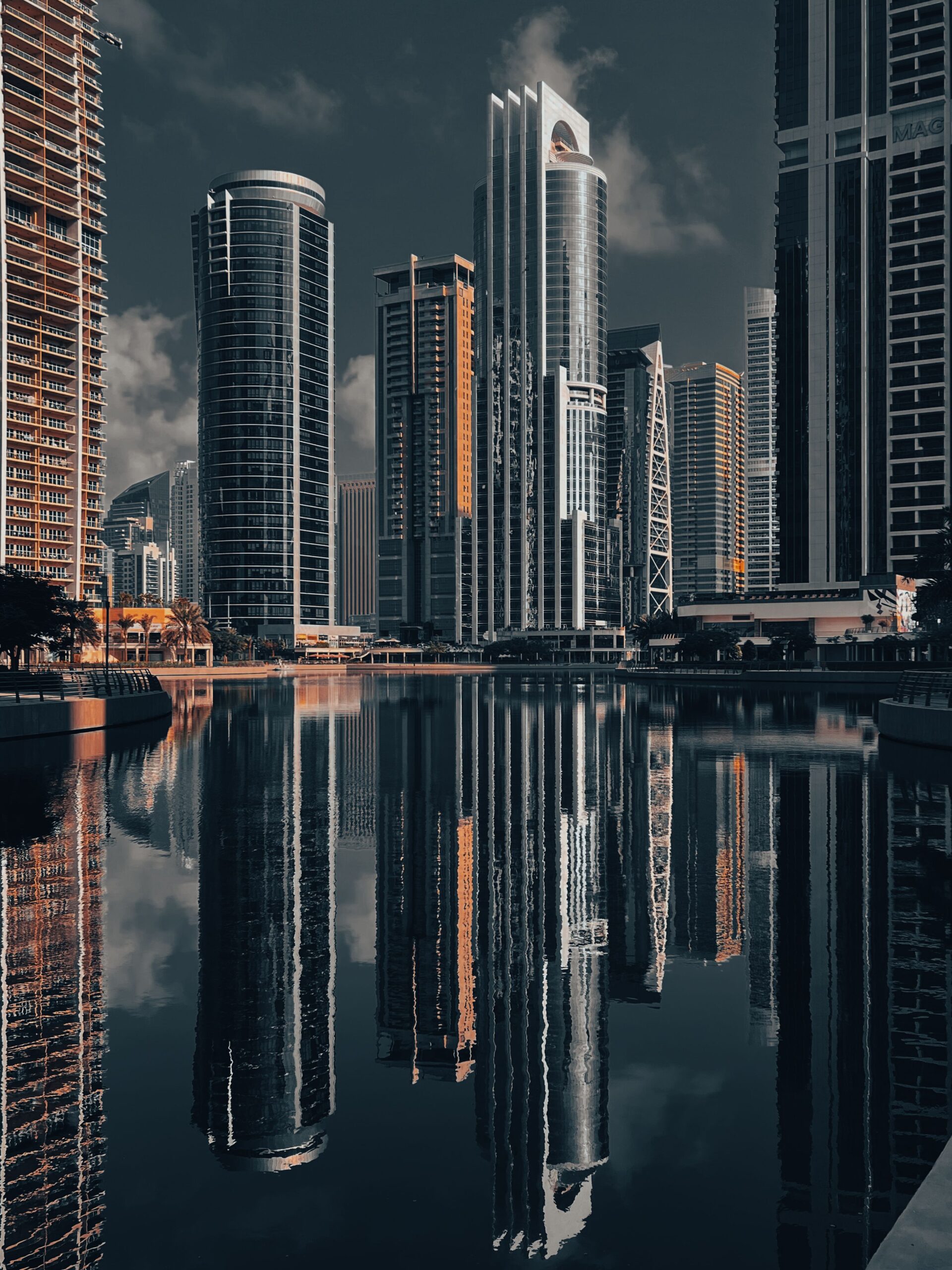 Dubai skyline with high-rise towers reflected in a calm waterfront lake, representative of Lake View in Jumeirah Lake Towers Cluster B