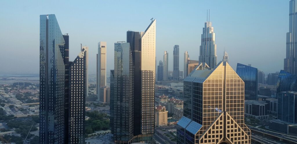 Daytime aerial view of Downtown Dubai skyscrapers along Sheikh Zayed Road with Burj Khalifa visible in the distance, no people visible