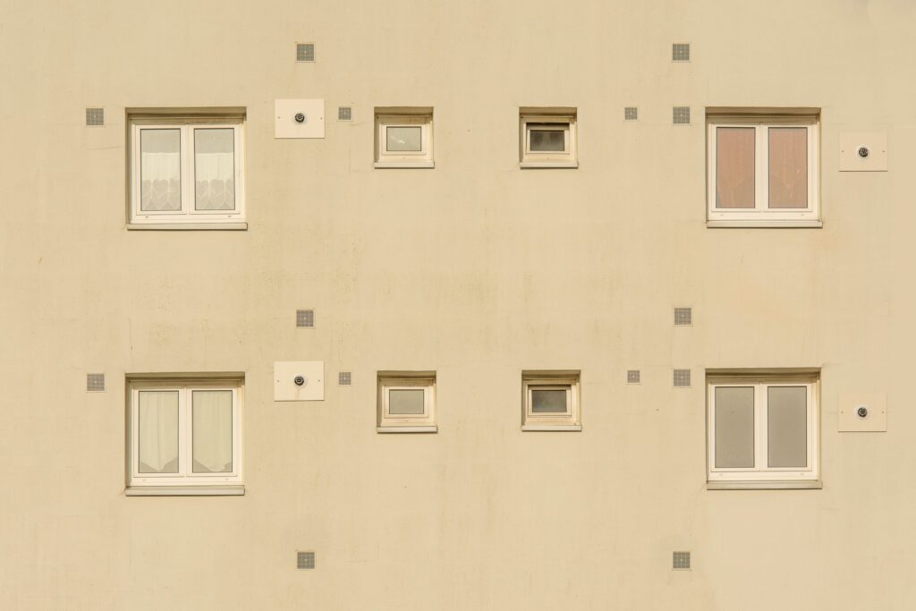Close-up of a beige apartment building facade in Dubai with symmetrical windows