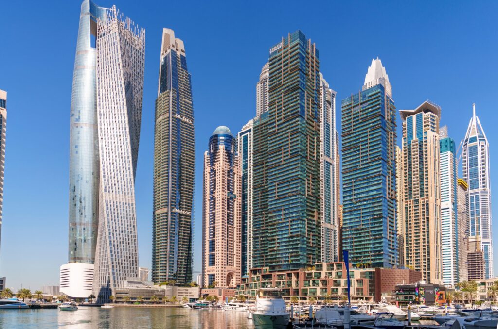 Skyscrapers lining the Dubai Marina waterfront during the day