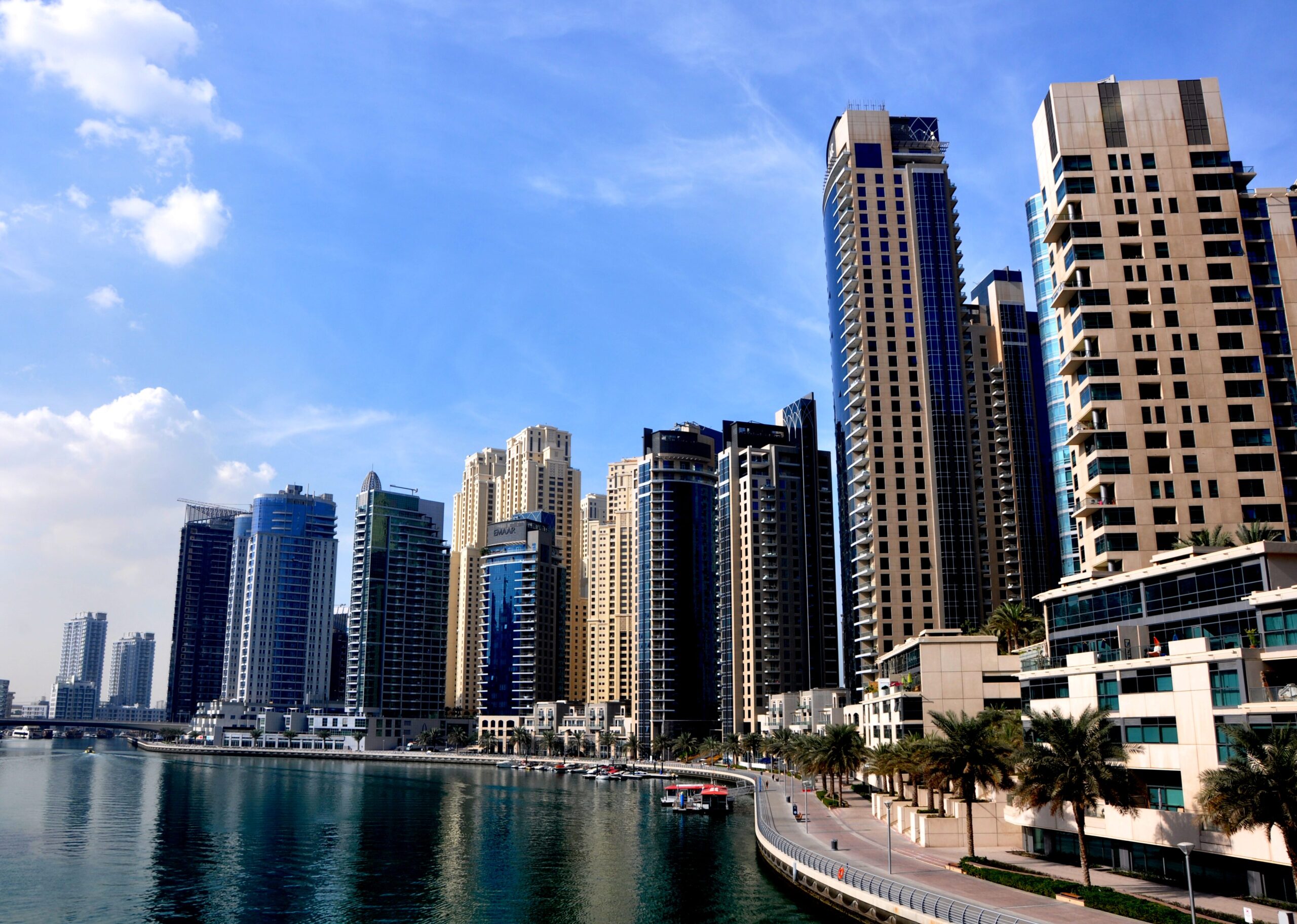 Daytime view of Dubai Marina's waterfront promenade and residential towers near Marina Cove