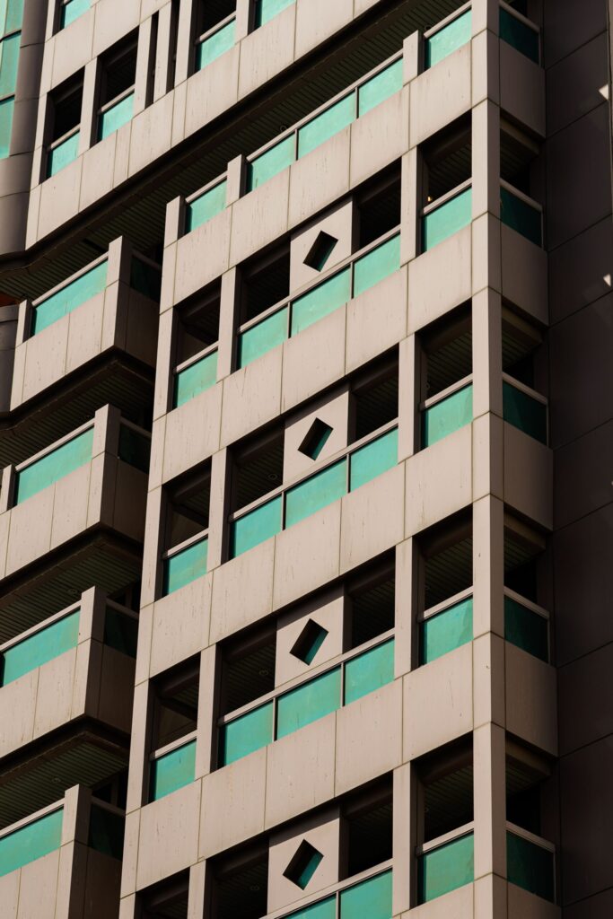 Close-up of a geometric-patterned modern high-rise facade with diamond-shaped window accents, Dubai