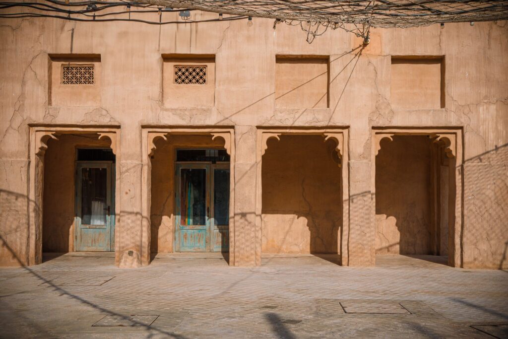 Sandstone Old Town-style courtyard with carved arched doorways in Downtown Dubai, near Miska 1
