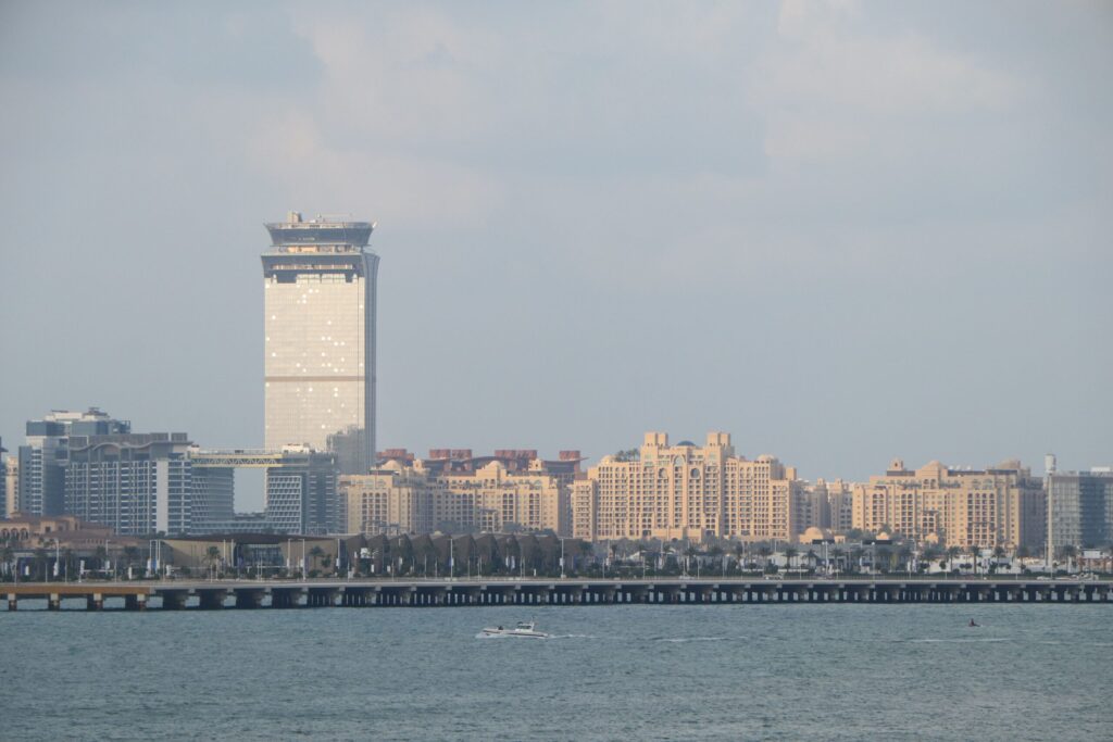 The Palm Tower and low-rise trunk apartment buildings across the water near Golden Mile 9, Palm Jumeirah