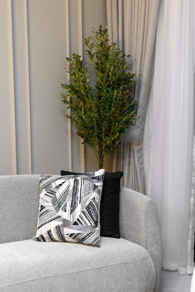 Stylish living room interior with grey sofa and decorative pillows in a Dubai apartment