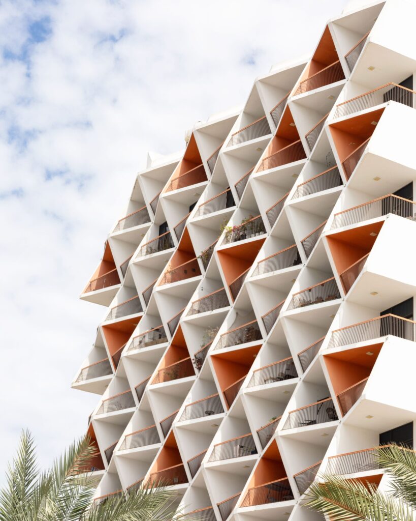 White and terracotta geometric balcony facade with palm fronds near Golden Mile 5, Palm Jumeirah