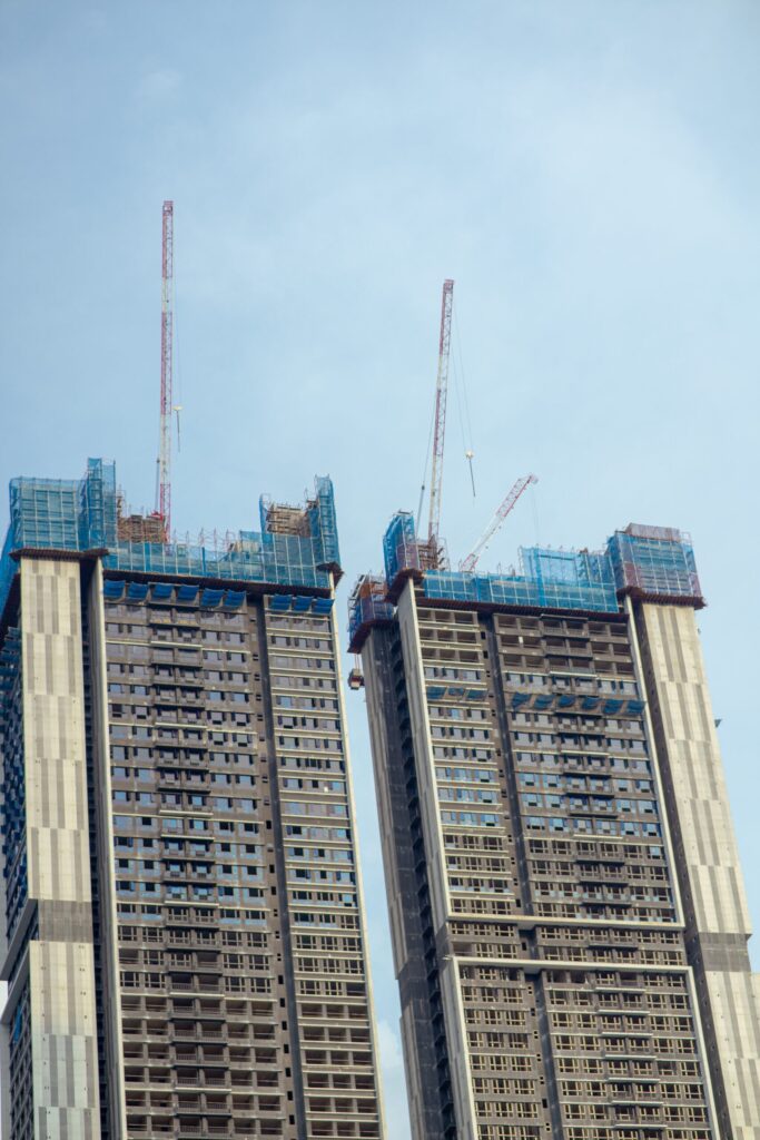 Twin high-rise towers under construction with cranes near 350 Riverside Crescent, Sobha Hartland II
