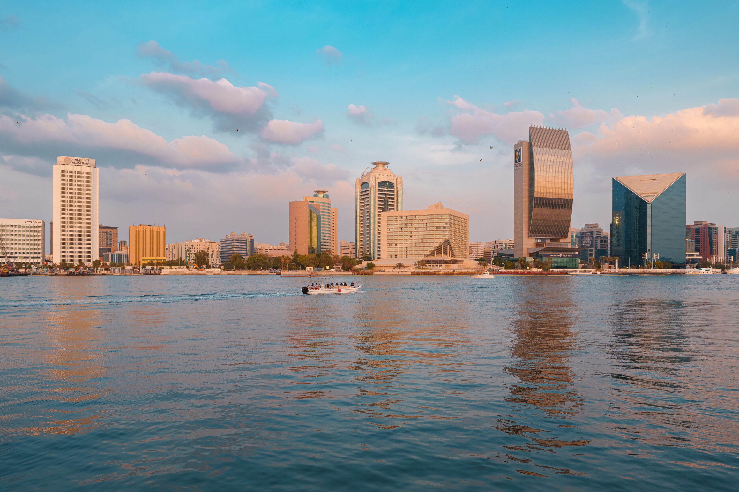 Dubai skyline and Dubai Creek waterfront at sunset near Ras Al Khor