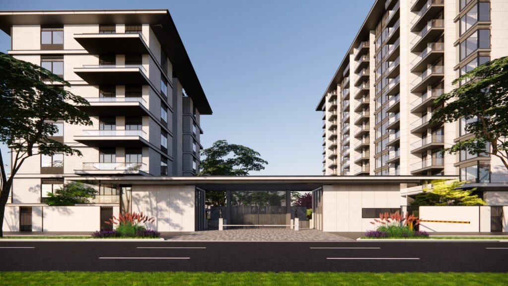 Twin apartment towers connected by a landscaped entrance near Bloom Heights, JVC