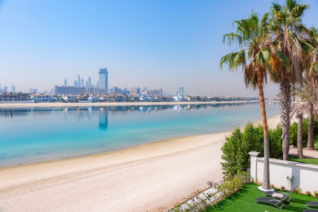 Palm Jumeirah beachfront with turquoise water and Dubai skyline near Six Senses Residences