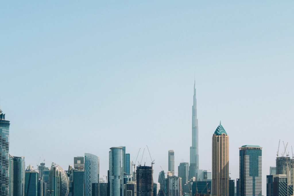 Dubai skyline with the Burj Khalifa and construction cranes, representative of the Business Bay area where Canal Crown is under construction
