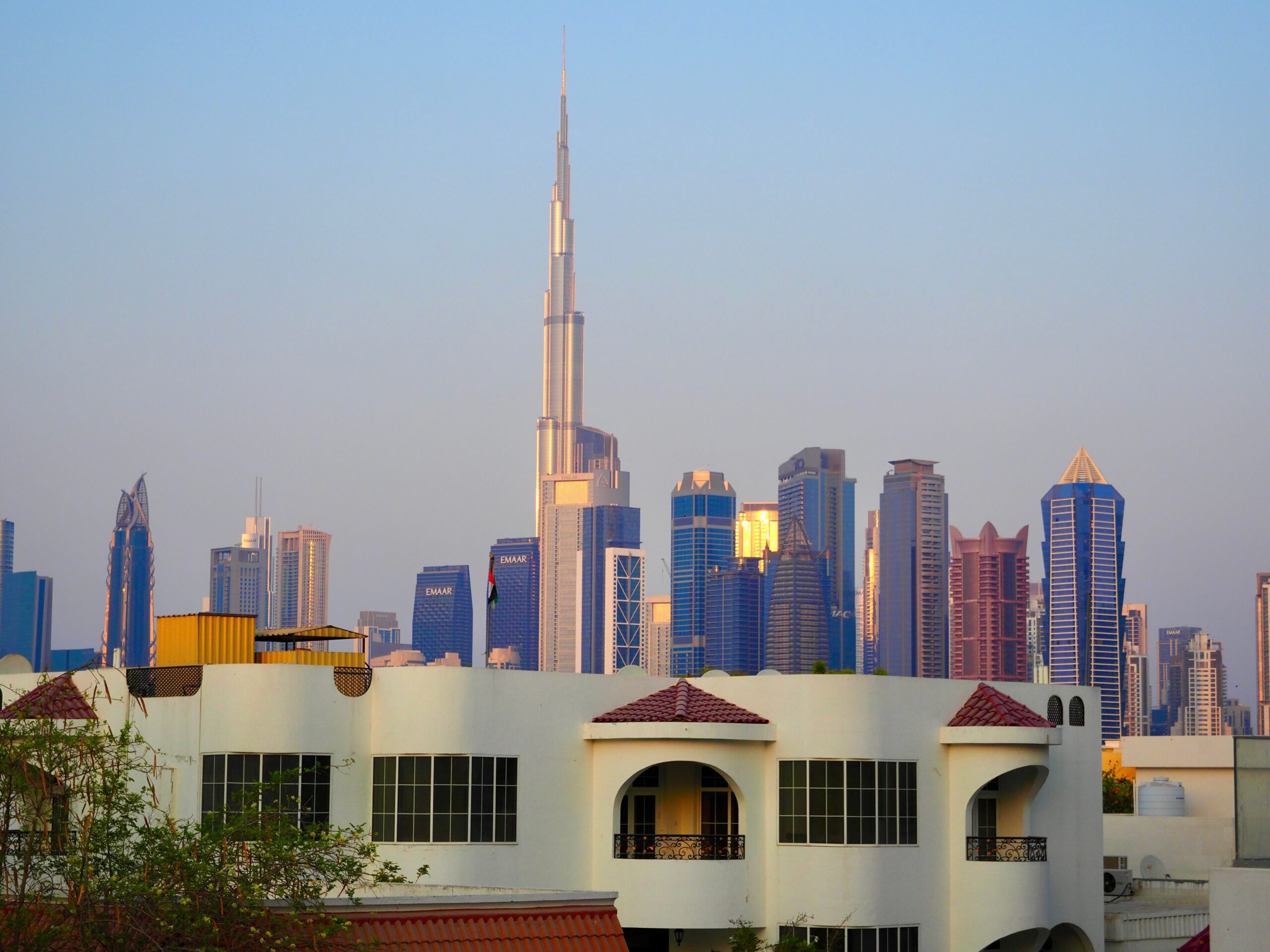 Burj Khalifa and the Dubai skyline rising behind villa rooftops