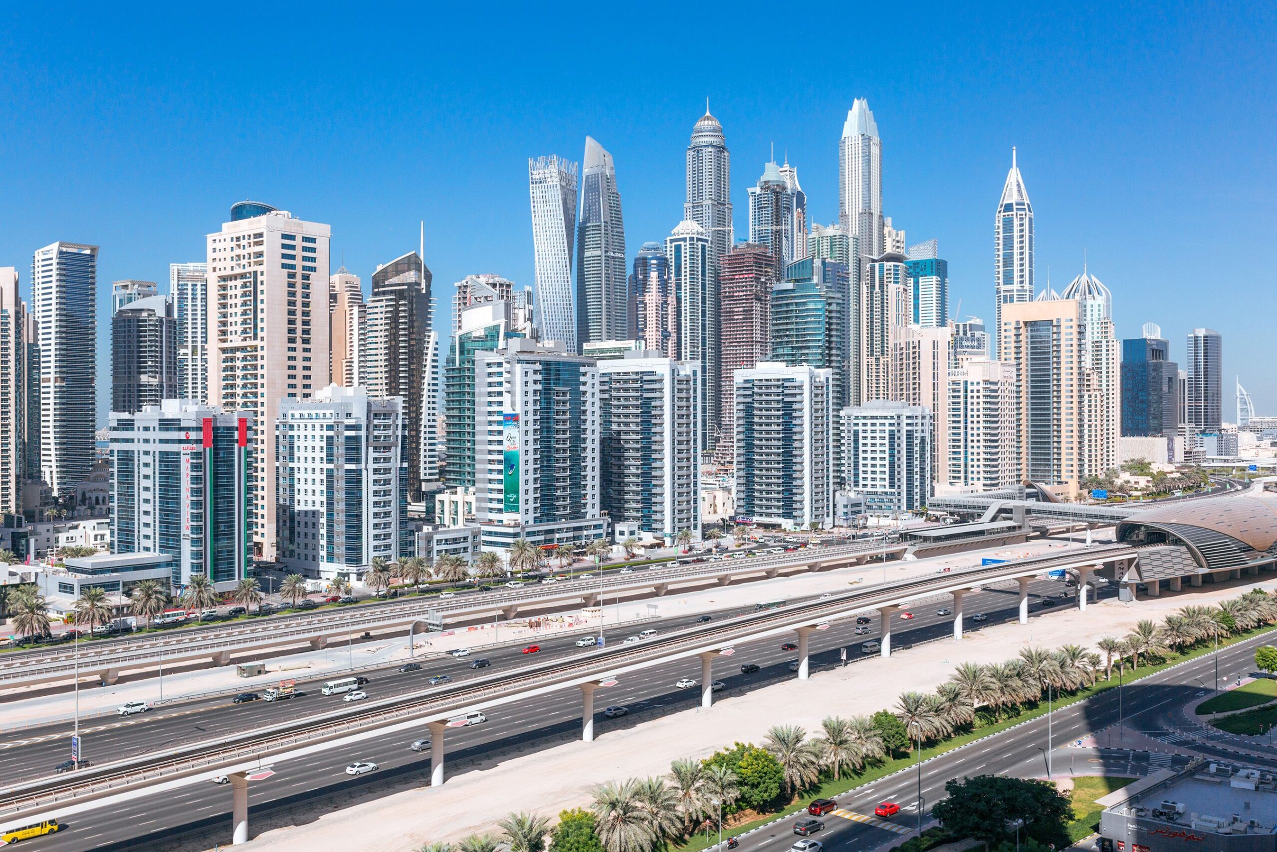 Dubai Marina skyline behind Sheikh Zayed Road on a clear day, near Al Husn Marina