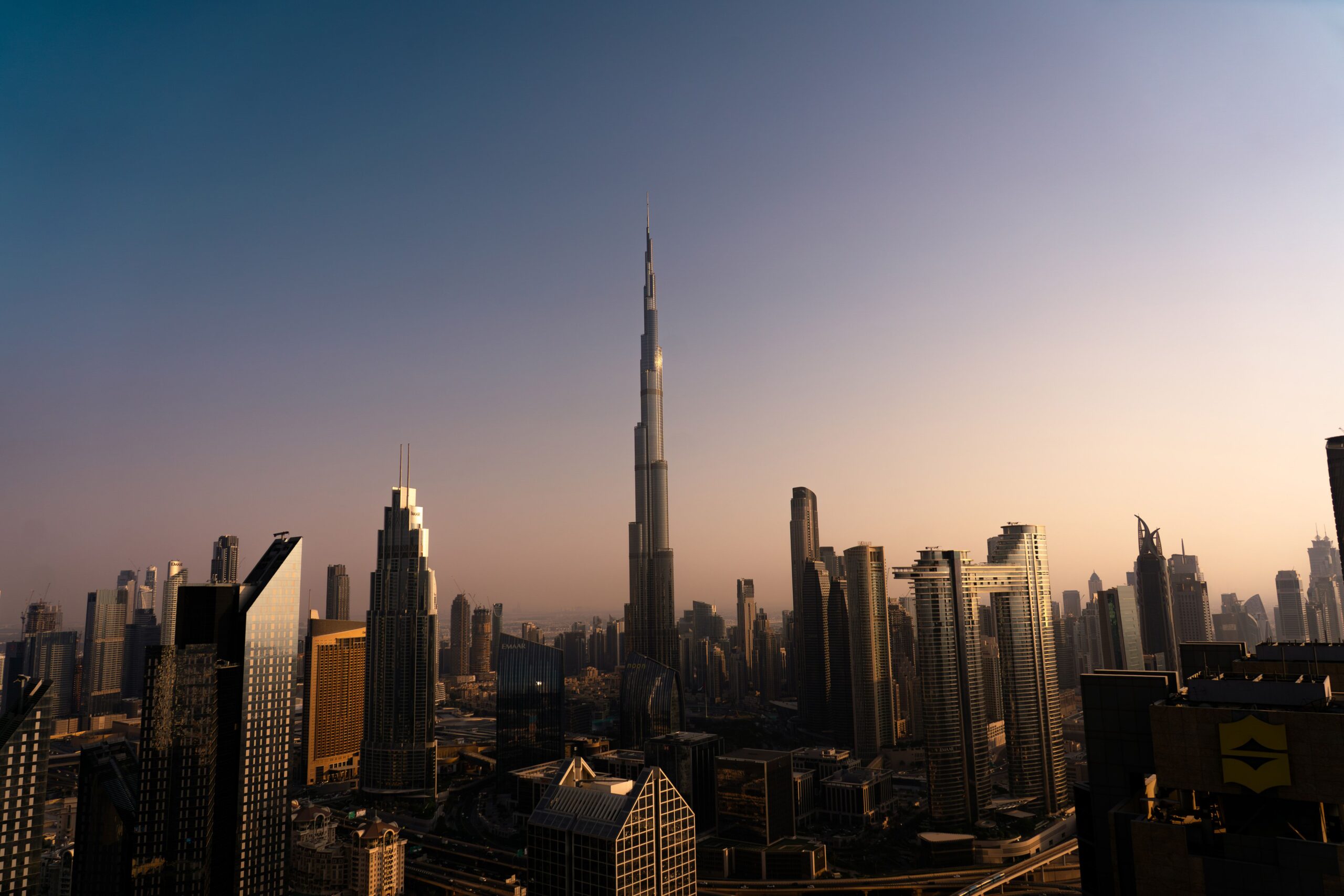 Dubai skyline at sunset with Burj Khalifa towering over Downtown Dubai