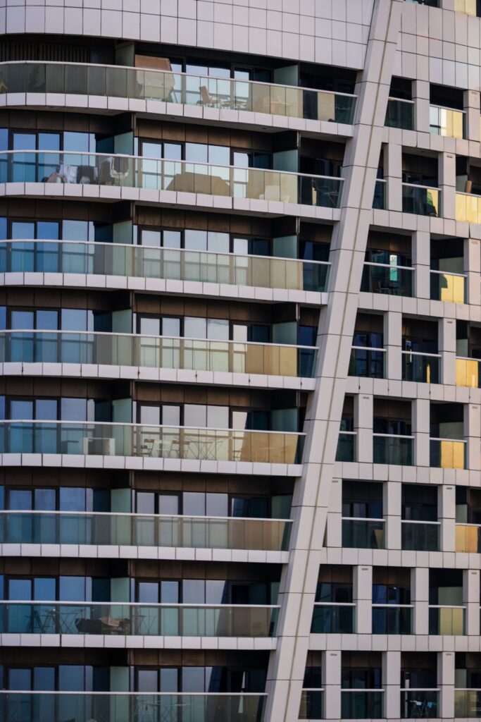 Close-up of a modern glass and metal high-rise facade, similar to The Highbury, Sobha Hartland