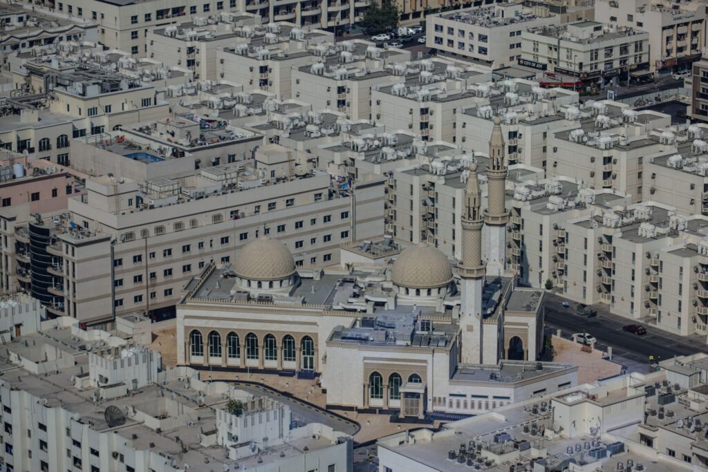 Aerial view of a mosque surrounded by residential buildings in Dubai