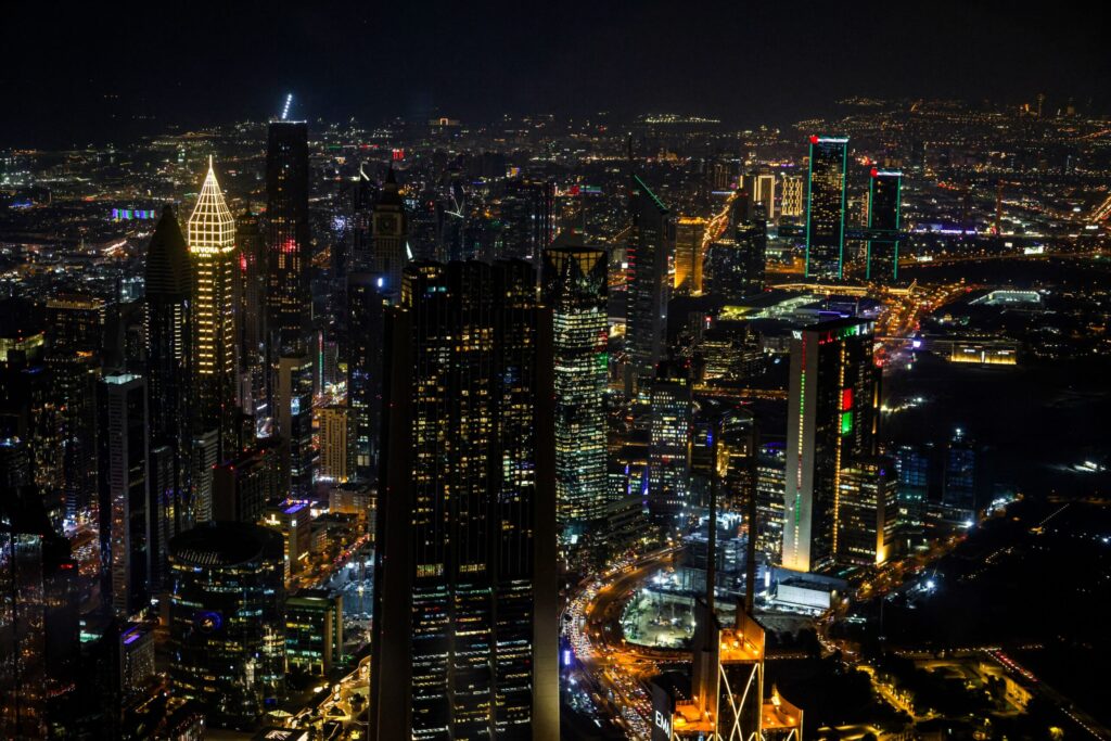 Aerial night view of Dubai's Sheikh Zayed Road skyline with illuminated skyscrapers near Business Bay