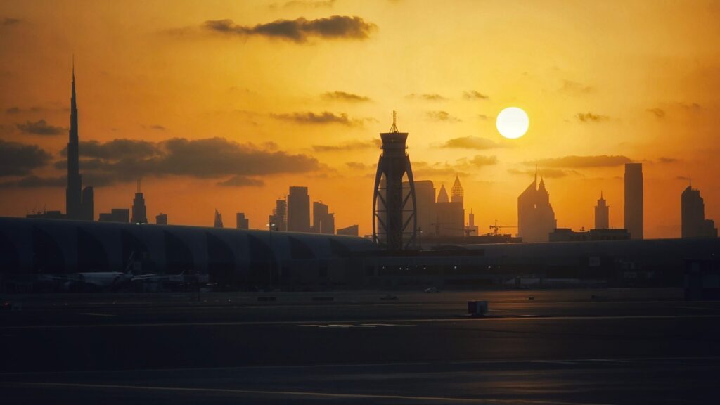 Dubai skyline in silhouette with a low sun at sunset