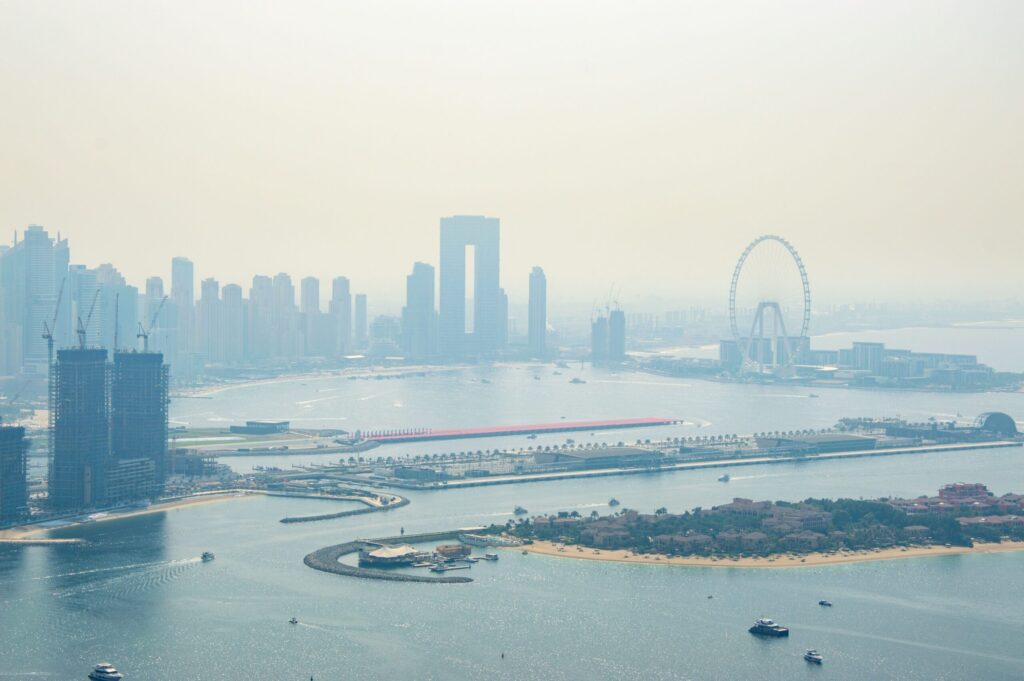 Aerial view of the Dubai waterfront skyline with a Ferris wheel