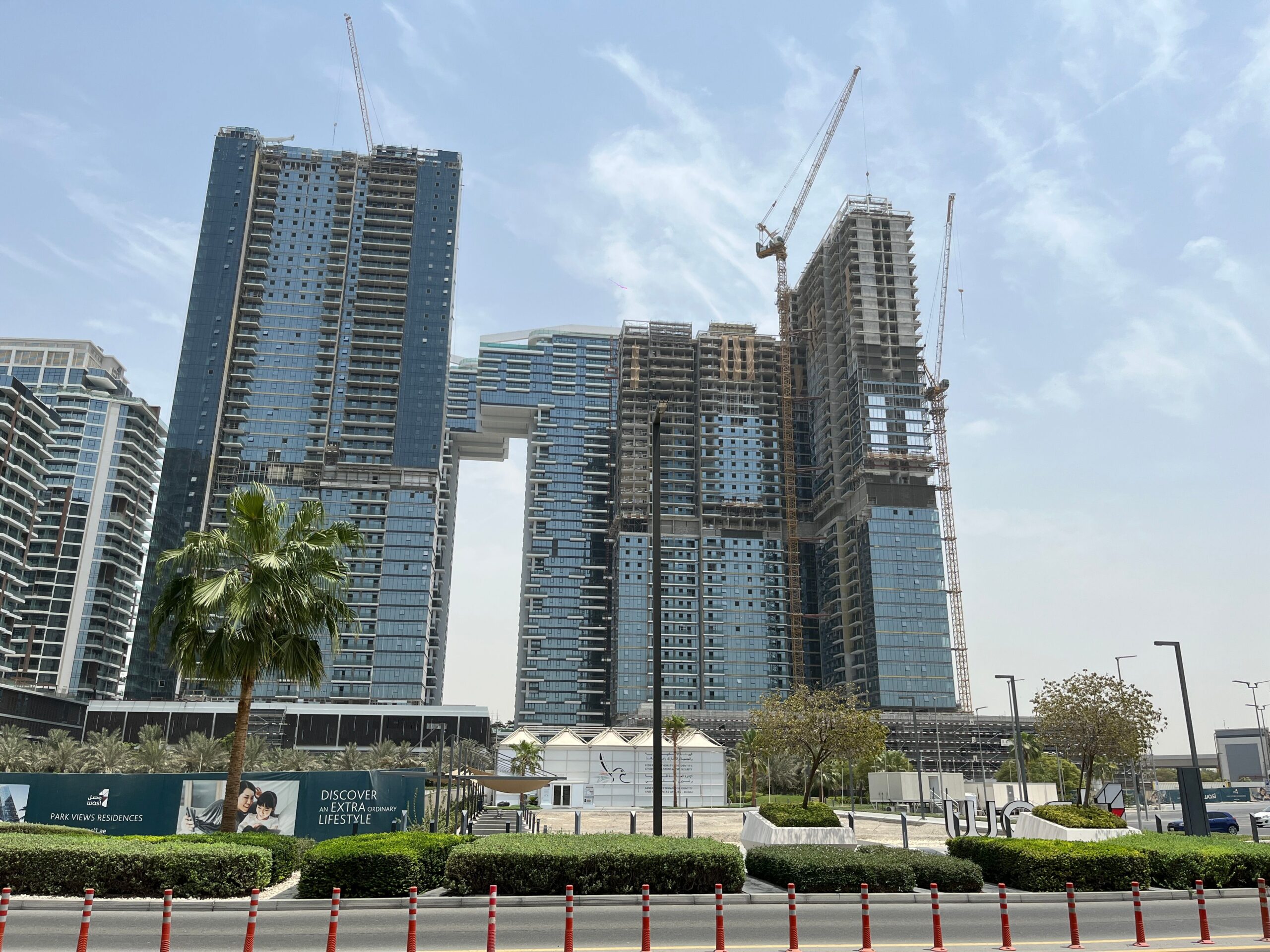 Residential towers under construction with cranes in Dubai