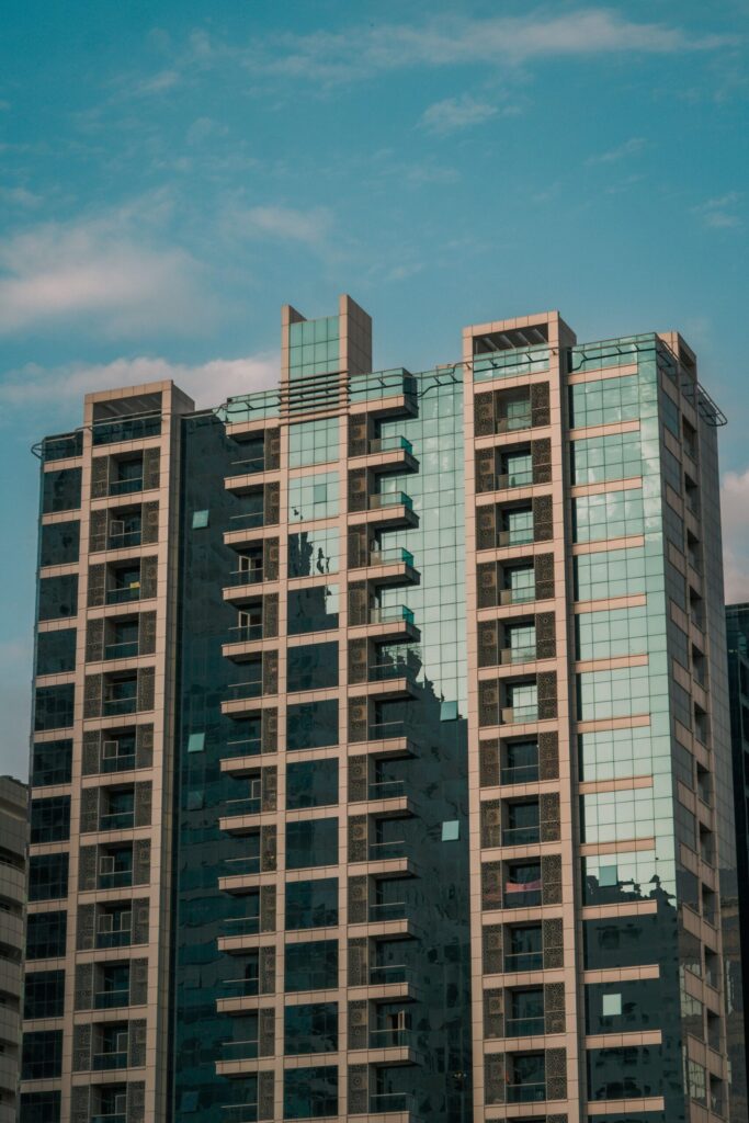 Modern high-rise apartment tower facade in Dubai Marina under a clear blue sky
