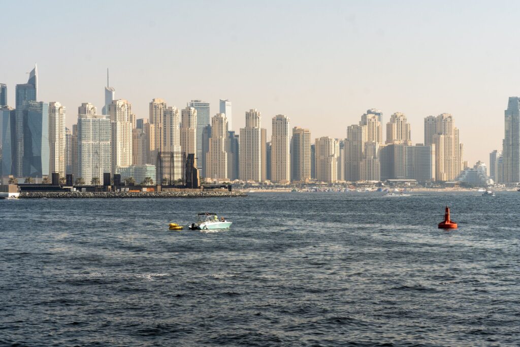 Dubai Marina skyline with boats on calm water on a sunny day