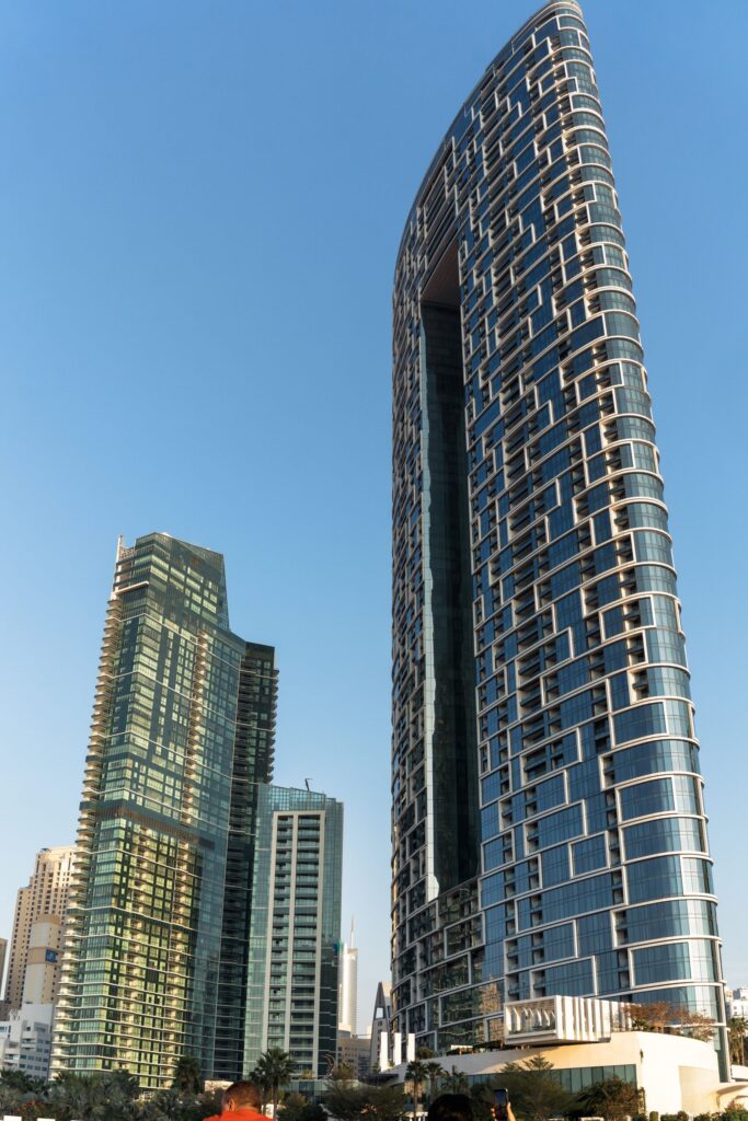 Modern glass high-rise towers under a clear blue sky in Downtown Dubai, near Bellevue Tower 1