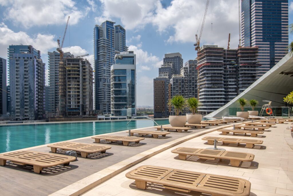 Rooftop infinity pool overlooking a Dubai skyline under construction near Crest Grande, Sobha Hartland
