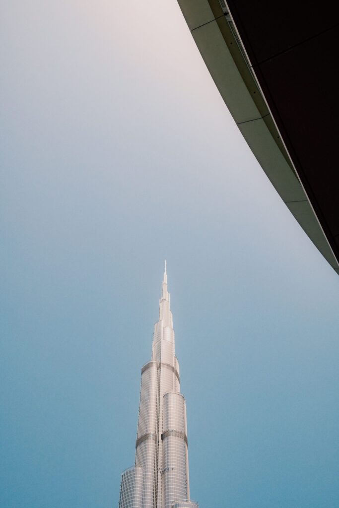 Low-angle view of the Burj Khalifa spire against a clear blue sky in Downtown Dubai