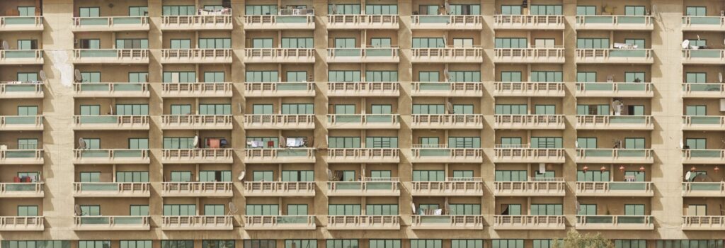 Mid-rise Dubai apartment building facade with rows of balconies