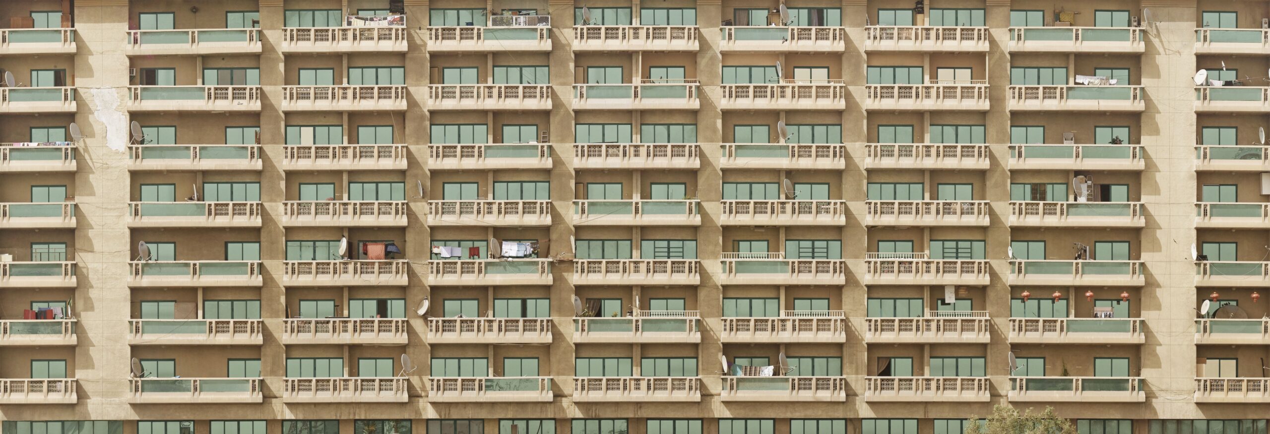 Mid-rise Dubai apartment building facade with rows of balconies