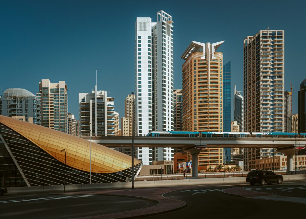 Dubai residential towers beside an elevated metro line