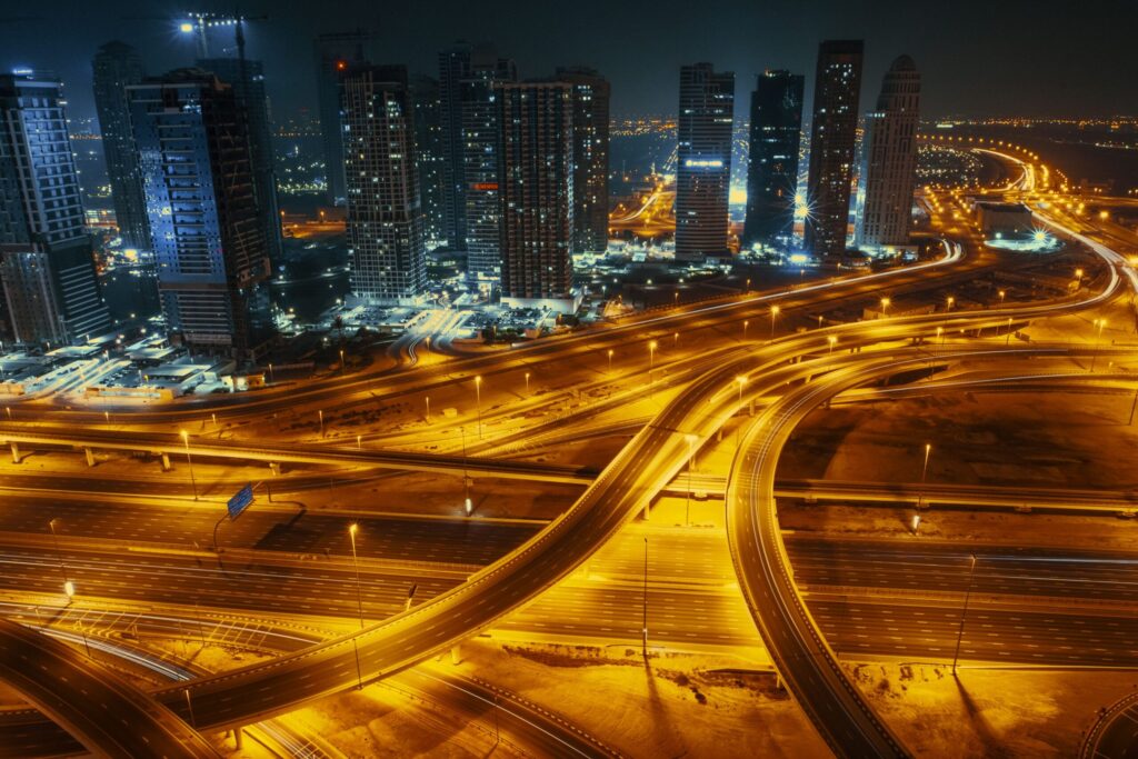Illuminated highway interchange and residential towers in Dubai at night
