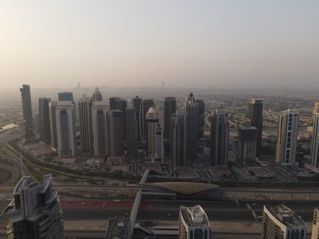 Dubai high-rise skyline at dusk, near Jumeirah Village Circle