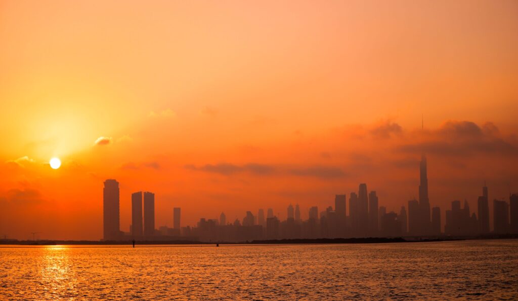 Golden hour glow over the Dubai skyline seen from the waterfront