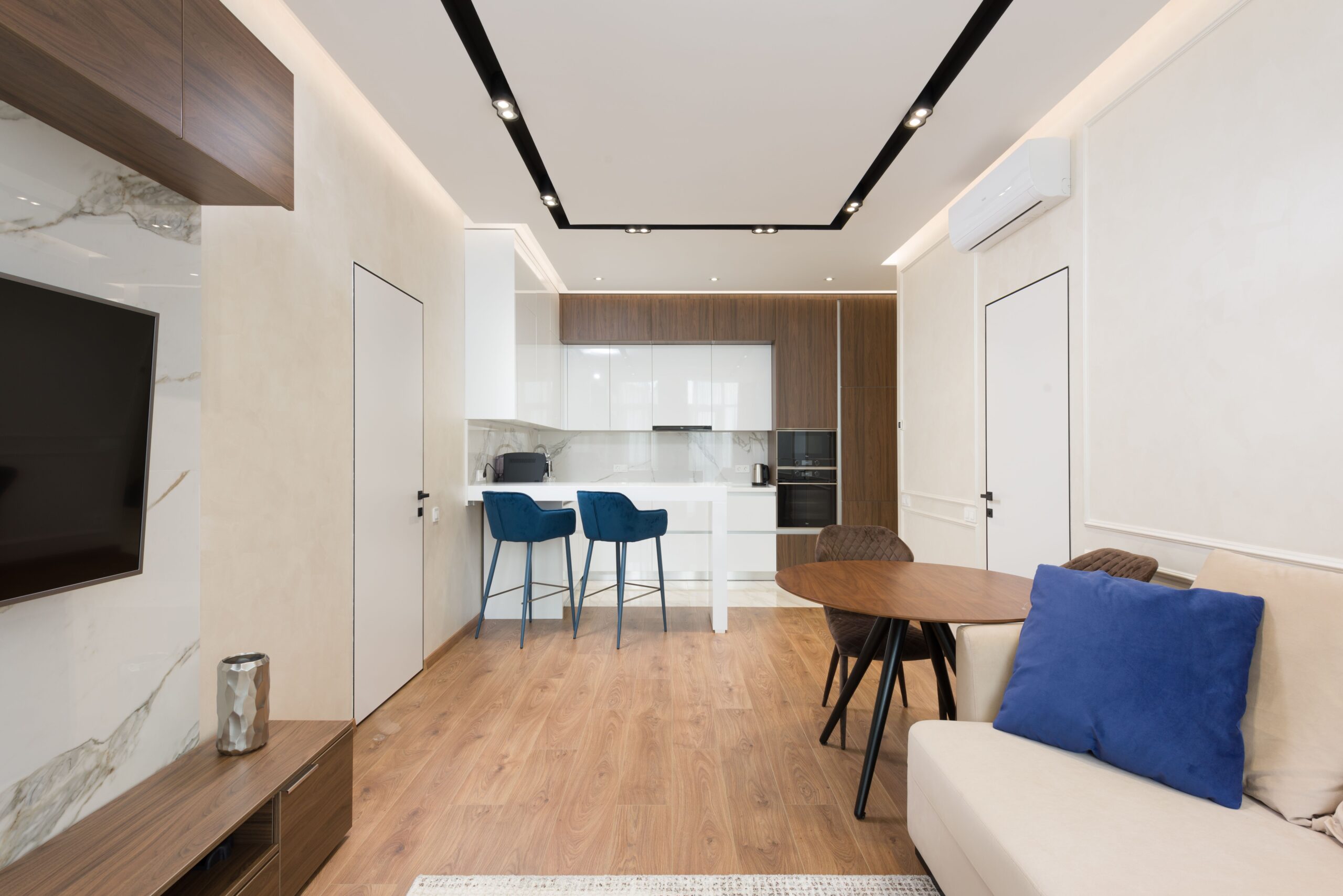 Modern furnished apartment with an open kitchen, bar stools and a living area