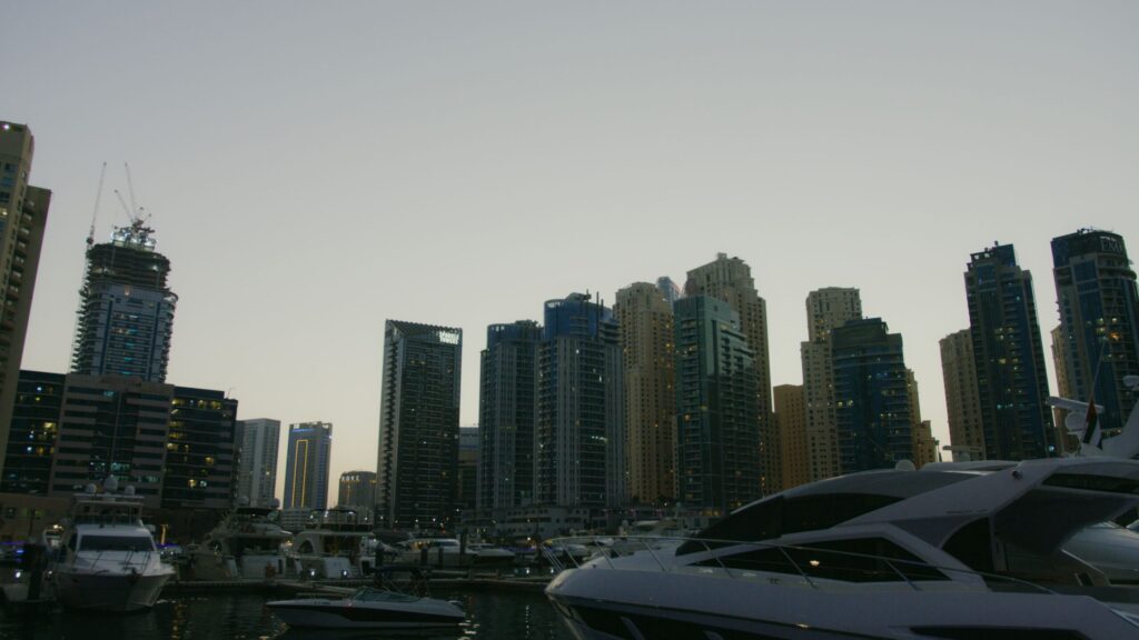 Waterfront residential towers and moored yachts at dusk, representative of Lakeshore Tower's Cluster Y setting in Jumeirah Lake Towers, Dubai