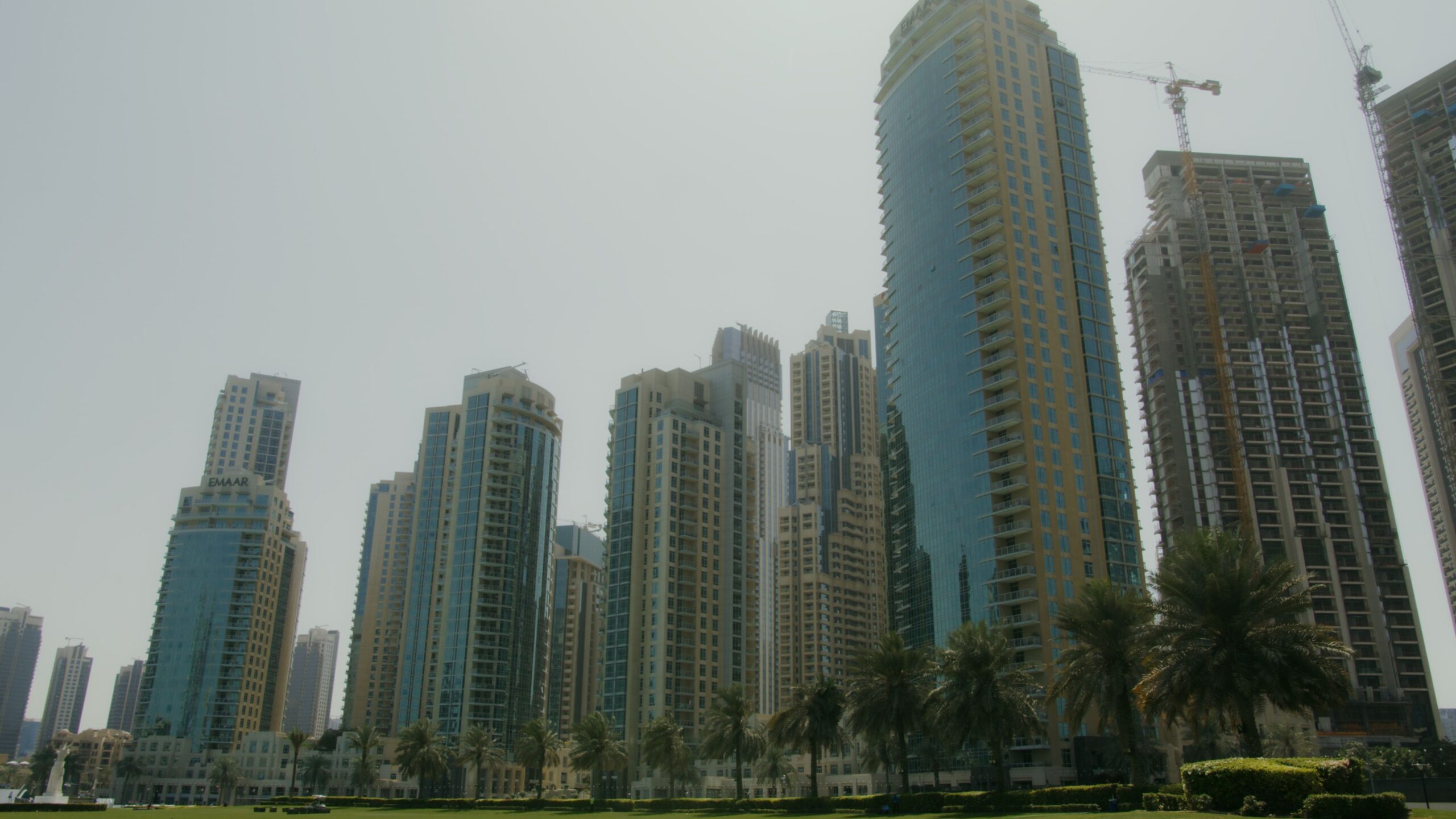 Dubai skyline with a residential tower under construction and a crane, near Business Bay